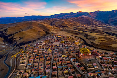 High angle view of buildings and mountains against sky