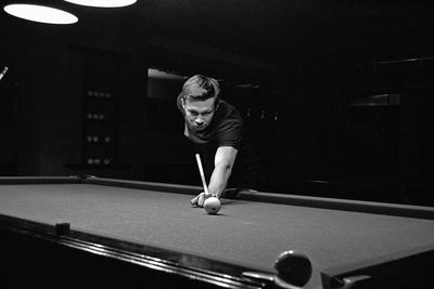 Young man playing snooker