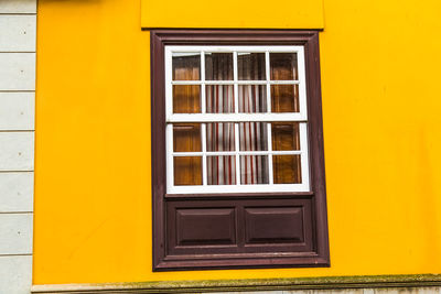 Closed door of yellow house