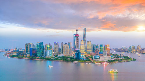 View of buildings against cloudy sky during sunset