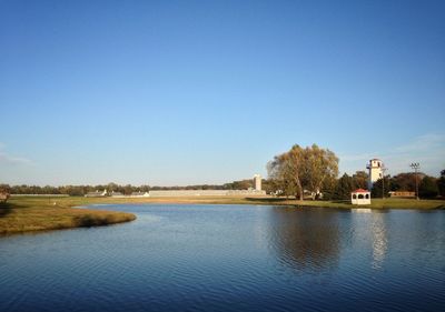 Scenic view of river against clear blue sky