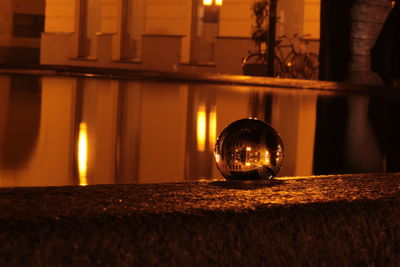 Close-up of illuminated lamp on table