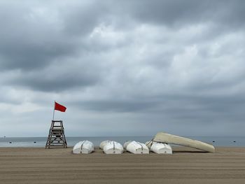 Lifeguard hut on beach against sky