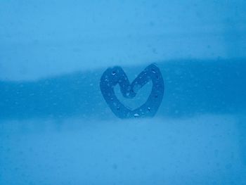 Close-up of heart shape on glass window