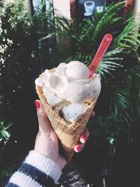 Close-up of hand holding ice cream cone
