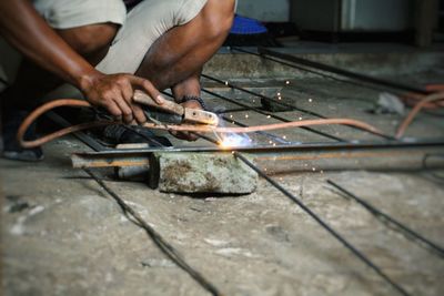 Low section of man working in workshop