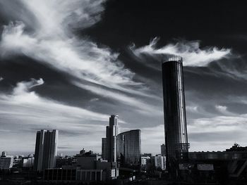 Low angle view of modern building against cloudy sky