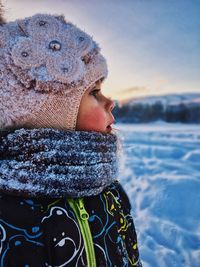 Close-up of woman in sea against sky during winter