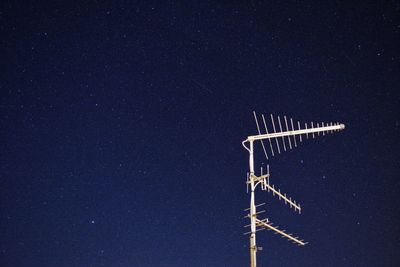 Low angle view of aerial against clear sky at night