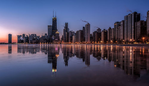 Reflection of chicago in lake michigtan at night
