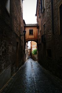 Alley amidst buildings in city