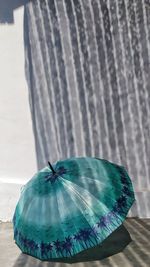 Close-up of wet umbrella on beach