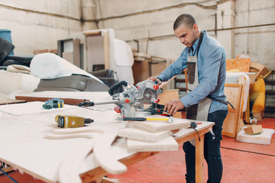 Side view of man working in workshop