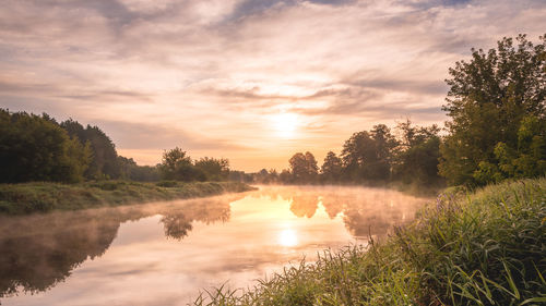 Scenic view of lake against sky during sunset