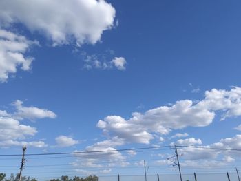 Low angle view of cables against blue sky