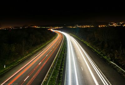 Light trails on road in city at night