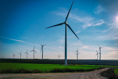 Windmill on field against sky