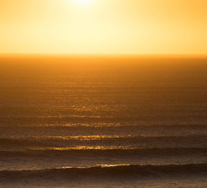 Scenic view of sea against clear sky during sunset