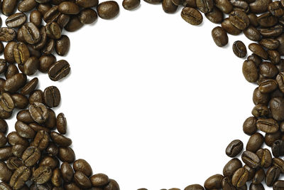 Close-up of coffee beans against white background