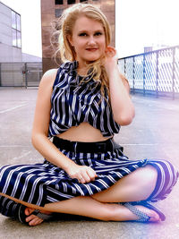 Portrait of young woman sitting outdoors