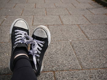 Low section of person standing on footpath