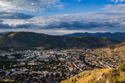 High angle view of houses and mountains against sky