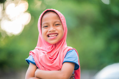 Portrait of smiling girl standing outdoors