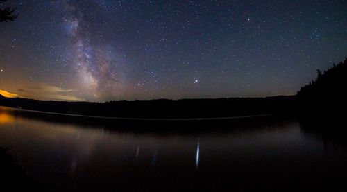 Scenic view of lake against sky at night