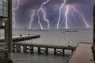 Lightning over sea against sky at night