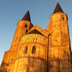 Low angle view of church against sky on sunny day