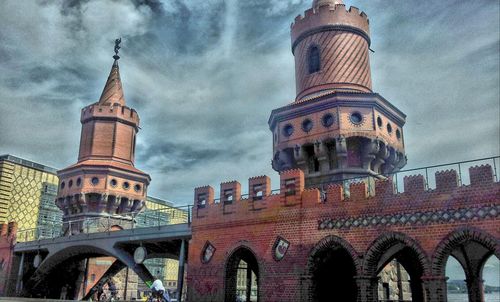 Low angle view of eiffel tower against cloudy sky
