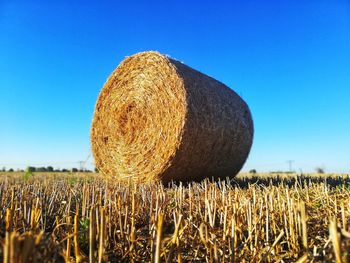 Hay bales on field against sky