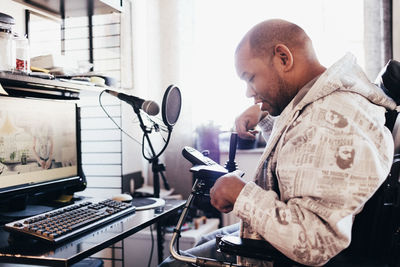 Side view of man using mobile phone