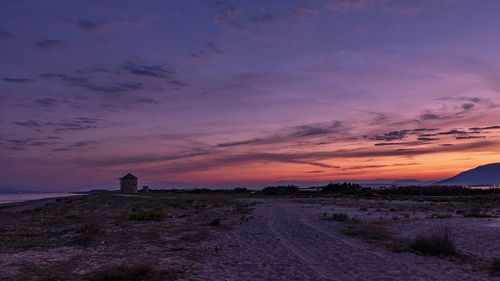 Scenic view of land against sky during sunset