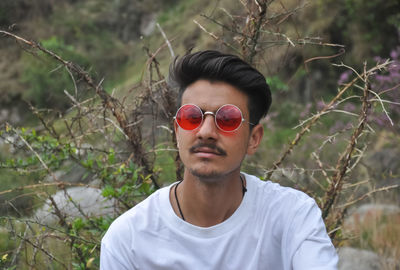 Portrait of young man wearing sunglasses and white t-shirt 