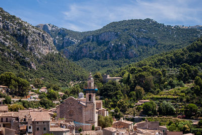 Trees and townscape against mountains