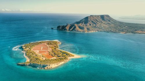 High angle view of sea and island against sky