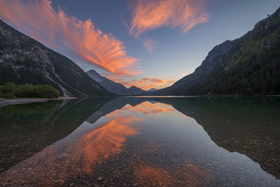 Austria, tyrol, clouds reflecting in heiterwanger see at dusk