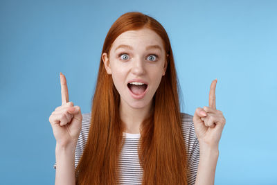 Portrait of woman against blue background