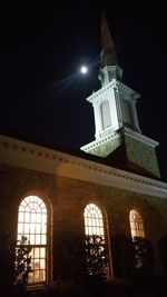 Low angle view of illuminated building against sky at night