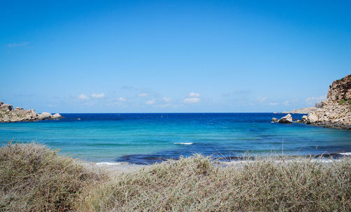 Scenic view of sea against blue sky