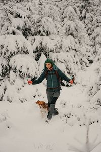 Girl playing with dog in the snow