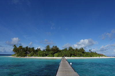 Scenic view of sea against blue sky