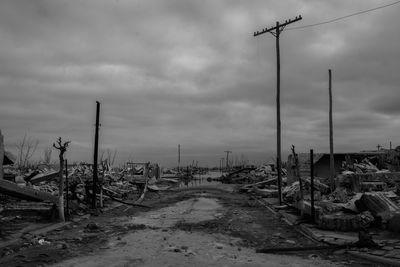 Abandoned railroad track against sky