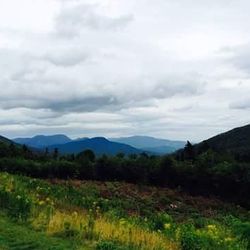 Scenic view of mountains against cloudy sky