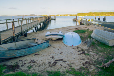 Omokoroa beach with four small boats dragged ashore.