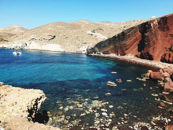 Scenic view of sea and mountains against sky