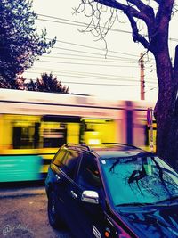 Blurred motion of yellow car on street in city