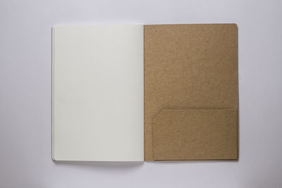 Directly above shot of open book against white background