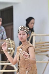 Young woman dancing indoors